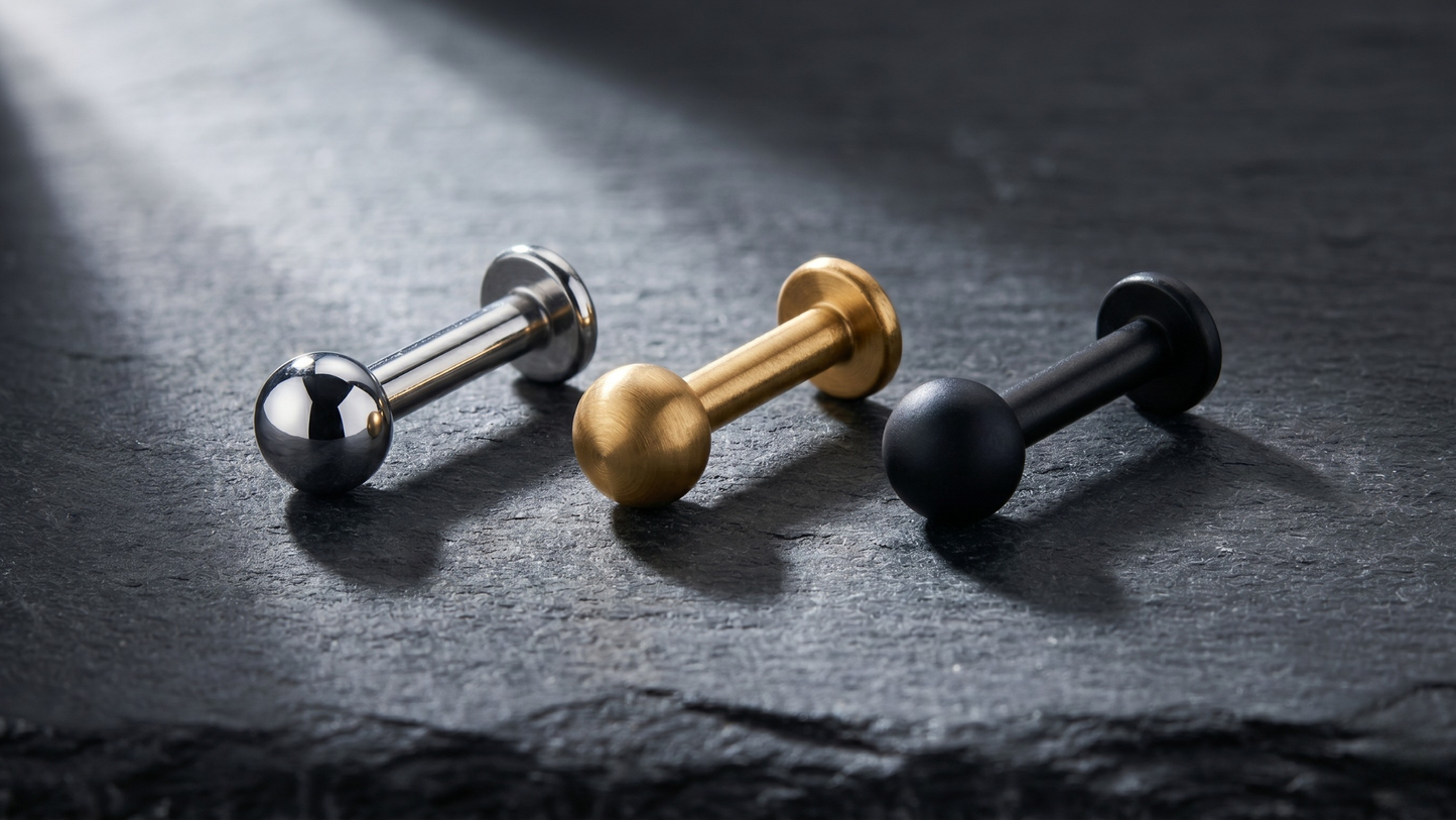 labrets lying side by side  titanium silver, PVD gold ,PVD black